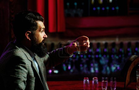 Photo for Bearded gentleman drink cognac. Sipping finest whiskey. Stylish rich man holding a glass of old whisky - Royalty Free Image