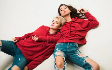 Feeling free and stylish. Couple women wear modern clothes for youth generation. Forever young. Couple hang out together. Carefree people. Youth just want to have fun. Freedom feeling. Youth fashion.