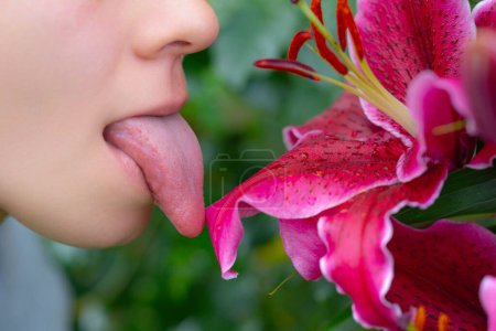 Photo for Sexy lick. Tongue and sexy female lips. Tongue out on flower background. Glamour art lips concept. Tongue icon. Sexy girl opening her mouth and showing the long big tongue - Royalty Free Image
