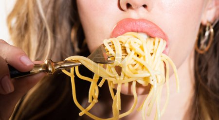 Photo for Woman lips enjoys pasta. Noodles on plate. Spaghetti is tasty. Enjoying Spaghetti. Pasta is choice. Noodles on fork lose up. A meal of spaghetti. Spaghetti in sexy mouth. Sexy bite. Lovely food. Sexy - Royalty Free Image