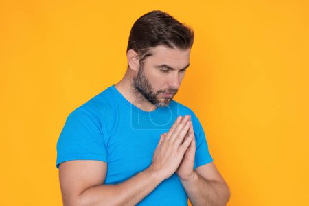 Photo for Christian Religion. A man is praying to God. Calm spiritual handsome man praying. Serious peaceful man with joining hands praying. Belief concept. Man praying. Male pray - Royalty Free Image