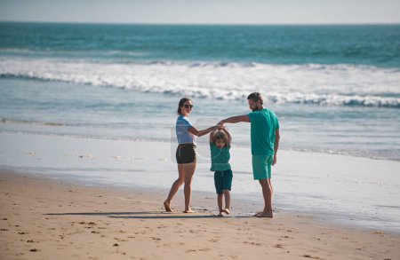 Photo for Happy young family run and jump on summer beach. Child with parents holding hands, family travel, vacation concept - Royalty Free Image