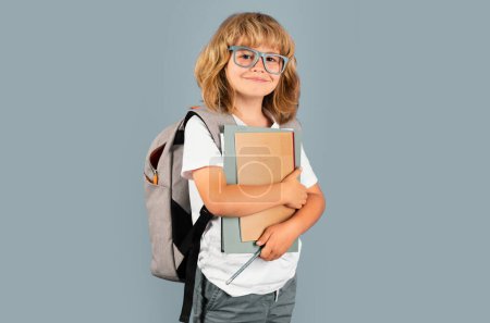 Photo for School little student hold books. Kids education concept. Child in school uniform. Portrait of happy smiling school kid. Positive emotions - Royalty Free Image