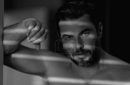 Cosmetics, body care and spa treatment. Portrait of masculinity charming shirtless man isolated over white background. Close-up portrait of attractive guy. Wellness, healthcare and hygiene