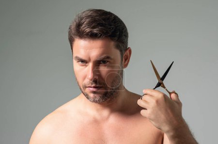 Photo for Man with scissors. Man cut hair with hairdressing scissors. Men haircut in studio. Barber scissors. Mens cut beard hair. Guy holding scissors - Royalty Free Image