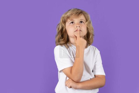 Photo for Child thinking on isolated background. Think and idea. Thoughtful kid studio portrait. Doubt and concerned kids expression - Royalty Free Image