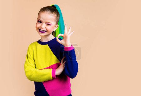 Photo for Portrait of cute nice magnificent little lady have thoughts ponder, hand showing a sign approx, dressing fashionable clothes isolated past-colored background - Royalty Free Image