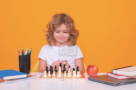 Photo for Child play chess on studio background. Kid playing chess. Clever child thinking about chess. Kids early development - Royalty Free Image
