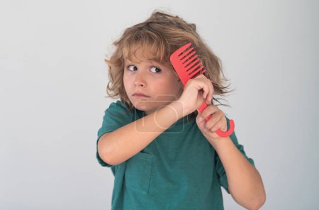 Photo for Comb and hair brush concept. Kid brushing tangled hair. Funny kids haircut - Royalty Free Image