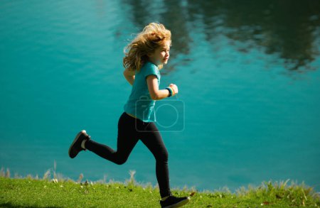 Photo for Child boy running outdoors. Child runner jogger running in the nature. Morning jogging. Active healthy kids lifestyle - Royalty Free Image
