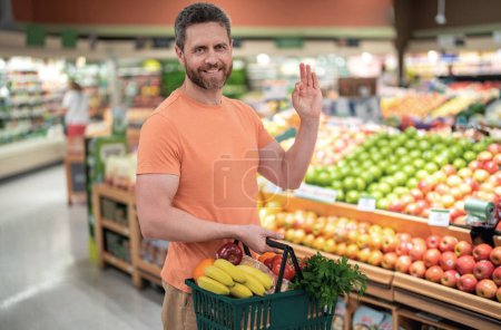 Photo for Portrait of hispanic man with shopping basket purchasing food in grocery store. Sales and shopping. Man buying products at supermarket. Supermarket and grocery shop. Discount, sale concept - Royalty Free Image