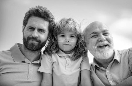 Boy son with father and grandfather, outdoor close up portrait. Fathers day. Men in different ages
