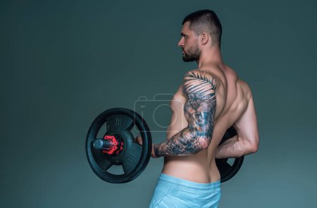 Photo for Fitness man in the gym. Young muscular man workout. Man with sexy strong body, strength and motivation. Fitness man at workout in gym pumping up muscles. Fitness and bodybuilding health - Royalty Free Image