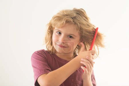 Photo for Haircare and kids hair styling. Little kid combing hair, isolated studio background - Royalty Free Image