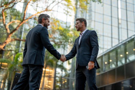 Business man shaking hands. Two businessmen handshake outdoor. Handshake business people. Handshake of two business man in suit outdoor. Businessmen great partnership