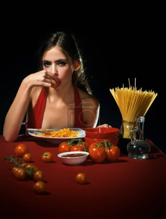 Photo for Close up sexy lips with noodles pasta. Female mouth eat pasta. Young beautiful woman eating spaghetti. Cuisine girl. Sexy woman eating pasta on kitchen. Woman cooked pasta - Royalty Free Image
