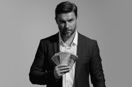 Successful business man counting money. Handsome middle age man holding bunch of 100 dollar banknotes. Guy holding money cash. Profit and financial success. Rich man with dollar cash