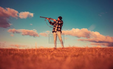 Photo for Hunter with shotgun gun on hunt. Illegal Hunting Poacher in the Forest. Hunting is the practice of killing or trapping animals - Royalty Free Image