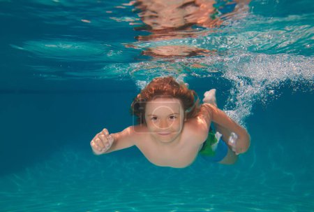Photo for Young boy swim and dive underwater. Under water portrait in swim pool. Child boy diving into a swimming pool. Cute boy swimming underwater in shallow turquoise water at tropical beach - Royalty Free Image