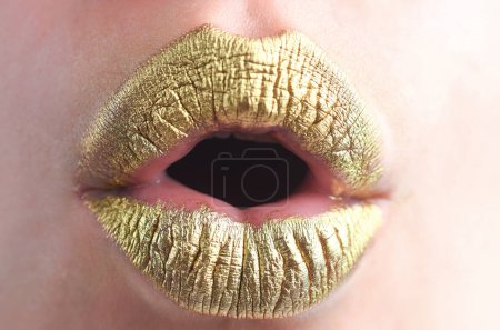 Photo for Surprised mouth. Close up woma face with gold lips. Gold paint on mouth. Golden lips. Luxury gold lips make-up. Golden lips with creative metallic lipstick. Gold metal lip. Sensual woman mouth - Royalty Free Image