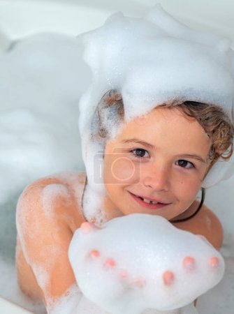 Photo for Kids shampoo. Foam on child head. Boy child in a bath with foam. Kids bathing and hygiene procedures - Royalty Free Image