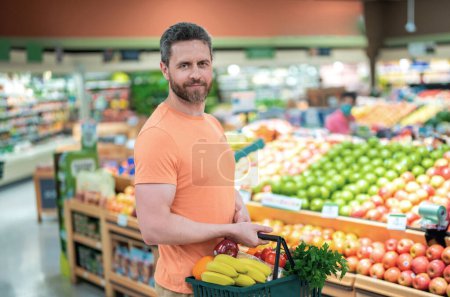 Photo for Store with people concept. Shopping at store, discount, sale concept. Man with shopping basket at store. Supermarket and grocery shop concept. Man customers buying products at store supermarket - Royalty Free Image