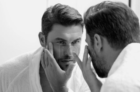 Male beauty. Cream treatment for male face. Beauty routine. Face of a beautiful man with perfect skin. Anti-aging and wrinkle cream. Concept of male beauty. Male skincare cosmetics concept. Skin care
