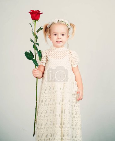 Photo for Retro style. happy birthday. wedding. small kid with red rose. happy childhood. love present. childrens day. little girl in vintage dress. Beauty. valentines day. romantic date. All you need is love. - Royalty Free Image