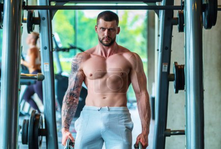 Photo for Man exercising with dumbbell. Male bodybuilder doing weight lifting workout at gym. Training with barbell. Muscled man strong muscular fit man workout with heavy weight. Exercises for muscular body - Royalty Free Image