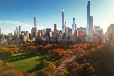 Autumn Central Park with downtown skyscrapers view from drone. Aerial of NY City Manhattan Central Park panorama in Autumn. Autumn in Central Park. Autumn NYC. Central Park Fall foliage
