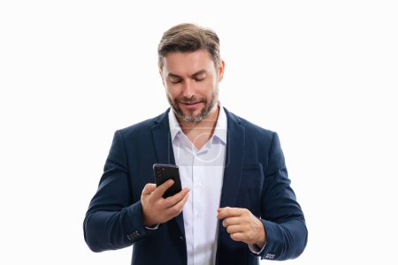 Photo for Handsome business man talking on phone. Business man in suit using smart phone isolated over studio background. Portrait of cheerful guy using cell phone, browse social media on phone - Royalty Free Image