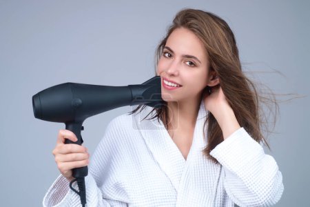 Photo for Brunette woman with hair dryer on studio background. Hairs style and beauty concept. Beautiful girl with hairdryer drying hair. Beauty model dries hair with hair dryer. Blow dryer - Royalty Free Image