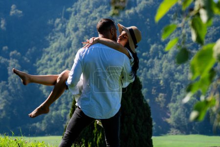 The sexy couple embraced passionately in the nature. Romantic kiss. Couple kiss on nature. Kissing couples. The romantic couple in love shared a kiss on the sun-kissed meadow
