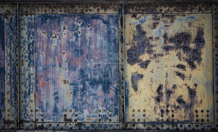 Photo for Photo closeup old rusty grunge steel aluminum fragment of protective structure made of metal plates sheets assembled with button head rivets on armor textured background, horizontal picture - Royalty Free Image