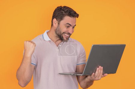 Photo for Hispanic excited man working on laptop in studio. Businessman checking email on laptop, writing message in social network, using internet, searching information on laptops. Successful business - Royalty Free Image