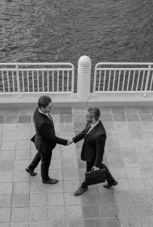 Business man shaking hands. Two businessmen handshake outdoor. Handshake business people. Handshake of two business man in suit top view. Portrait of successful business people outdoor