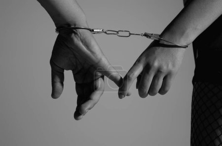 Photo for Woman and man hands in handcuffs. Close up of sexy couple hand in handcuffs. Domination, bdsm, love and fetish. Temptation couple handcuffed. Sex Toys. Male female hands in handcuffs. Love forever - Royalty Free Image