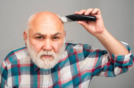 Bald man hairclipper, Mature baldness and hair loss concept. Middle aged gray man