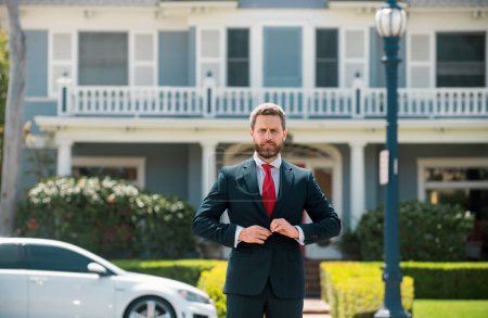Photo for Real estate agent welcoming visitors near new house. Portrait of realtor man - Royalty Free Image
