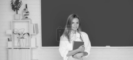 Photo for Female student on lesson lecture in classroom at high school or college - Royalty Free Image