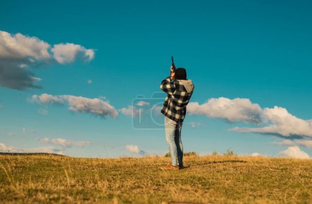Photo for Sporting clay and skeet shooting. Hunter with shotgun gun on hunt. Hunter in the fall hunting season - Royalty Free Image