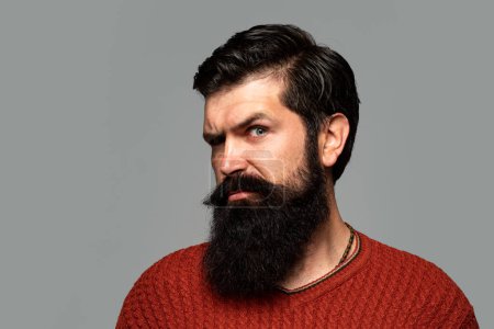 Bearded man. Beard Care. Facial Hair. Beard Styles and Male Grooming. Facial Hair Trends. Male face profile with beard and mustache. Cosmetics for bearded man with mustache. Serious man with beard