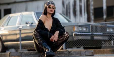 Photo for Hipster girl in sunglasses and bandana, black boots and jacket. Cheeky fashion girl. Hip-hop girl. Fashion woman outdoor. Stylish sexy young hippie. Youth fashion style and sexy casual clothes concept - Royalty Free Image