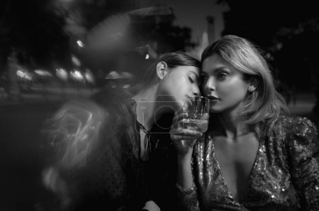 Photo for Night date. Two sexy girls. Young sexy couple women in night cafe dating. Sensual lesbians couple. Young female lovers posing sensuality. Lesbian foreplay. Two sexy girlfriends in night cafe dating - Royalty Free Image