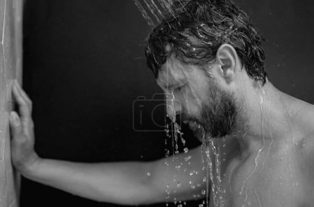 Photo for Man washing hair in bath. Guy bathing shower head in bathtub. Face in foam in shower. Bathing man taking shower. Close up guy showering. Shower concept. Man is under water drops in showers - Royalty Free Image