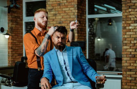 Old fashioned vintage barber shop pole. Male client getting haircut by hairdresser. Barbershop. Bearded man or hipster. Man visiting hairstylist in barber shop. He is doing styling with the shaver