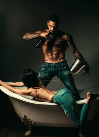 Champagne for pretty woman. Wine festival concept. Handsome man with tattooed body. Handsome brutal man on gray background. Mude male model with naked.