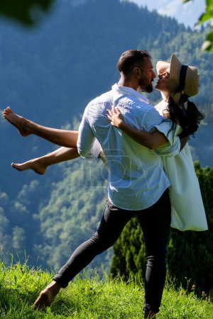 Summer vacation in nature. Couple enjoyed playful fun outside. Sexy couple hugged in nature. Sensual couple in love outdoors. The romantic couple in love shared a kiss on the sun-kissed meadow