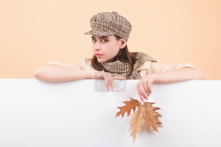 Photo for Studio portrait of young woman with autumn fall leaves - Royalty Free Image