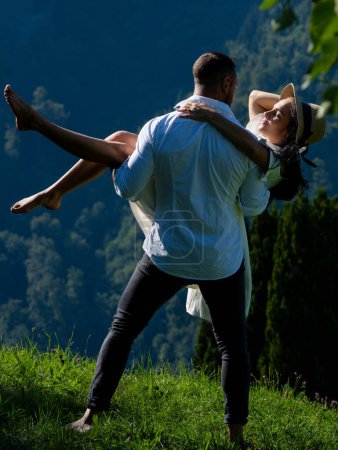 Summer vacation in nature. Couple enjoyed playful fun in nature. Sensual couple in love outdoors. Carefree couple cuddled in nature. He supports her with one arm while holding her hand